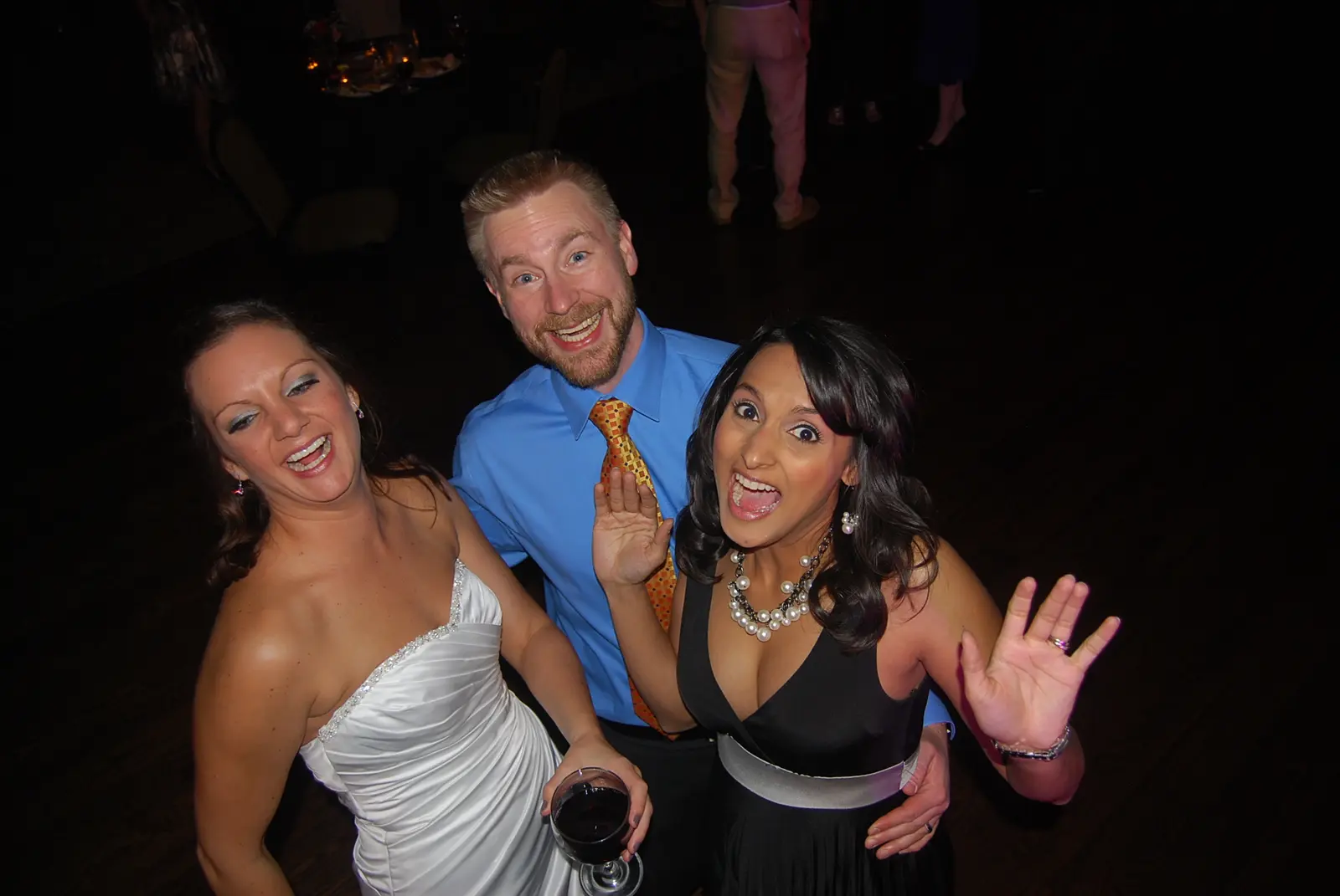 A bride celebrating with two friends