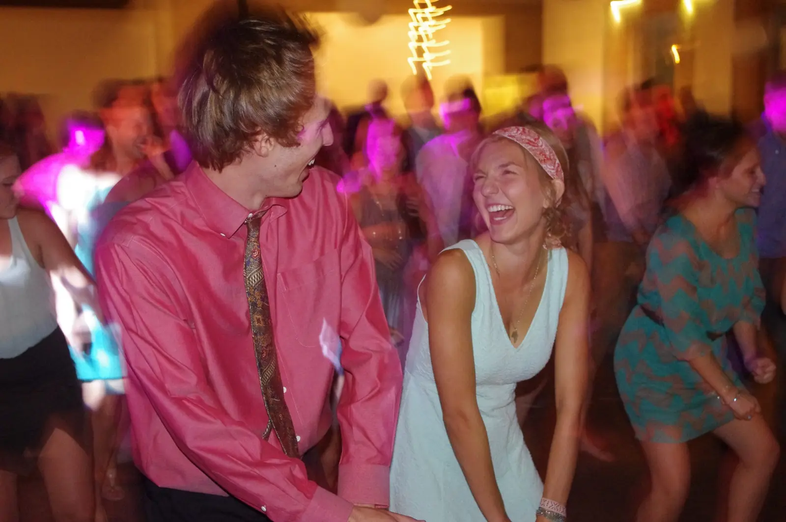 Wedding guests laughing and dancing together