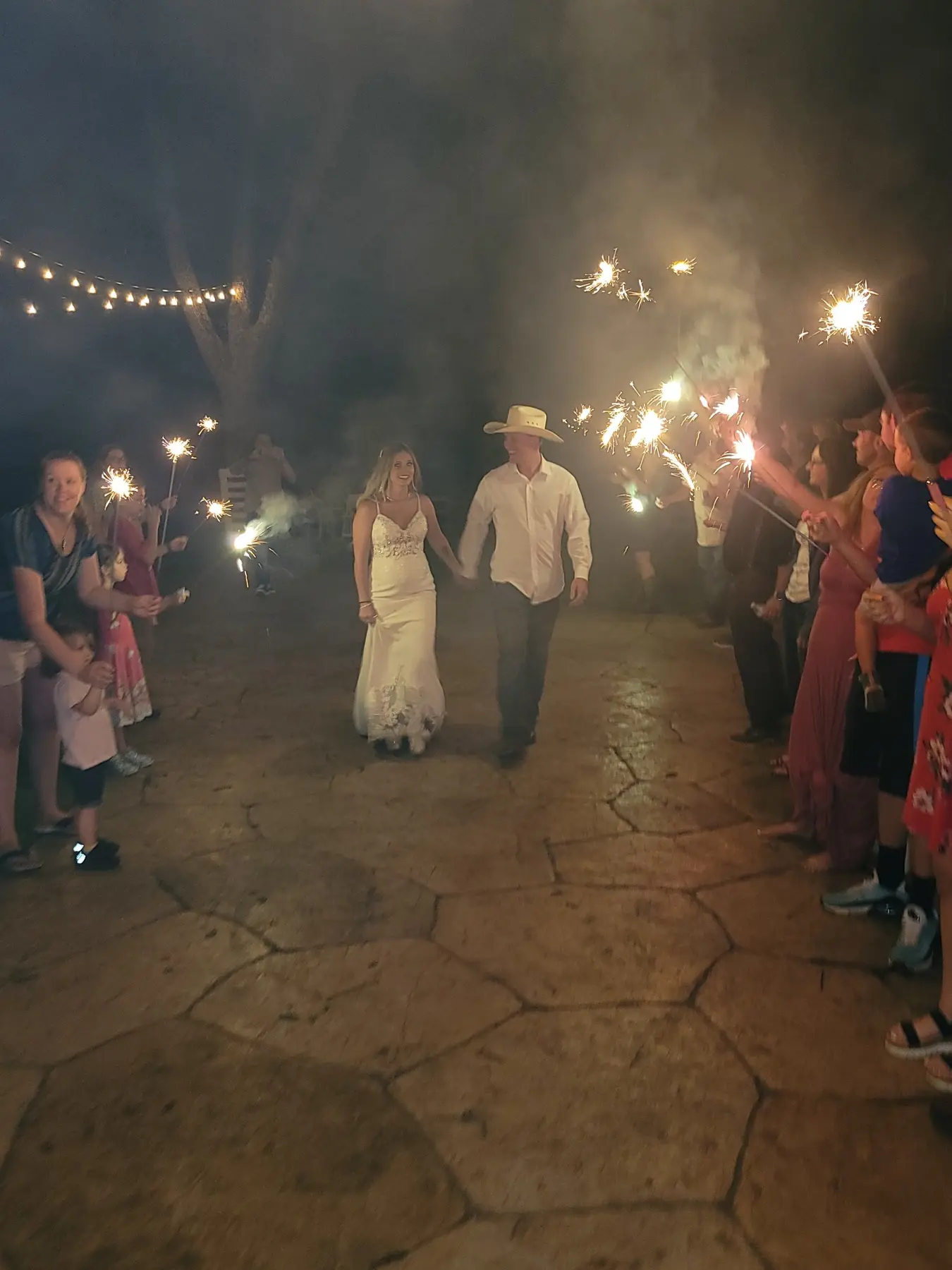 A newlywed couple walking through a sparkler send-off